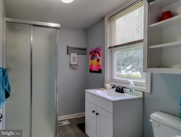 a bathroom with a sink vanity and a mirror