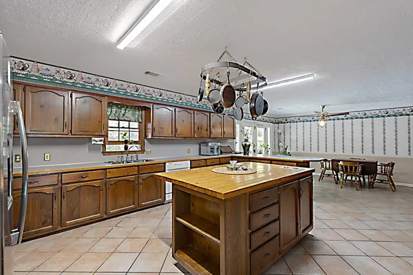 a kitchen that has a lot of cabinets and wooden floor