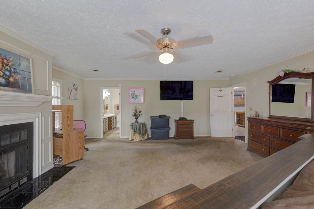 994 Ga Highway Fortson, GA 31808 - Photo 14 of 46 a living room with furniture a fireplace and a flat screen tv