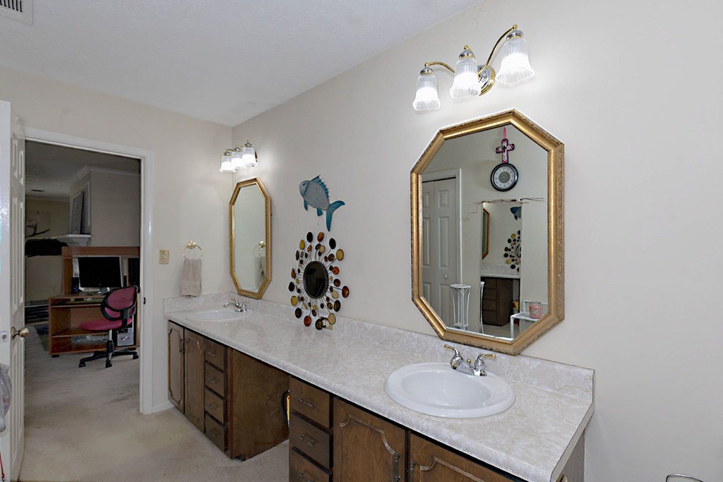 994 Ga Highway Fortson, GA 31808 - Photo 16 of 46 a bathroom with double vanity sinks and a mirror