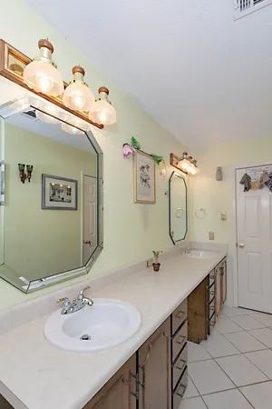 a bathroom with a mirror sink and toilet
