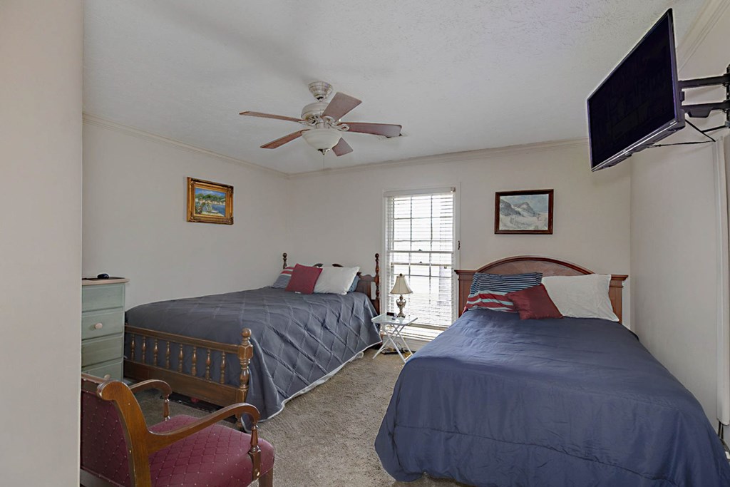 994 Ga Highway Fortson, GA 31808 - Photo 23 of 46 a bedroom with two beds and a flat screen tv