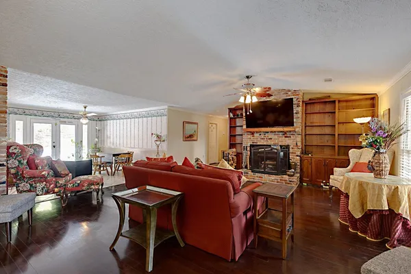 a living room with furniture a fireplace and a flat screen tv