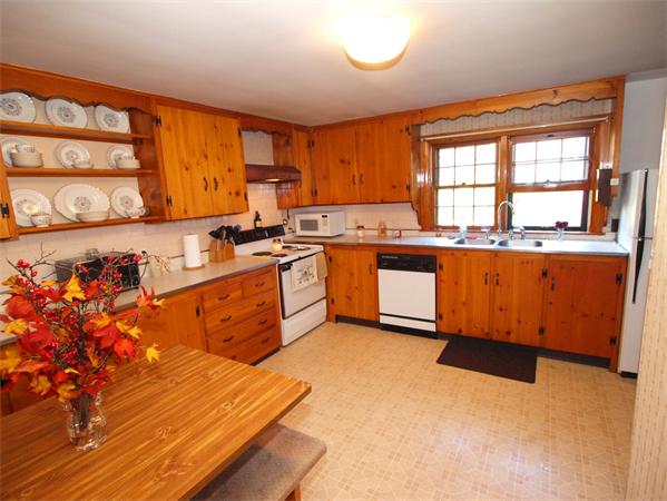 91 Randall Road Berlin, MA 01503 - Photo 10 of 30 a large kitchen with stainless steel appliances granite countertop a stove a sink dishwasher and a microwave oven with large wooden cabinets
