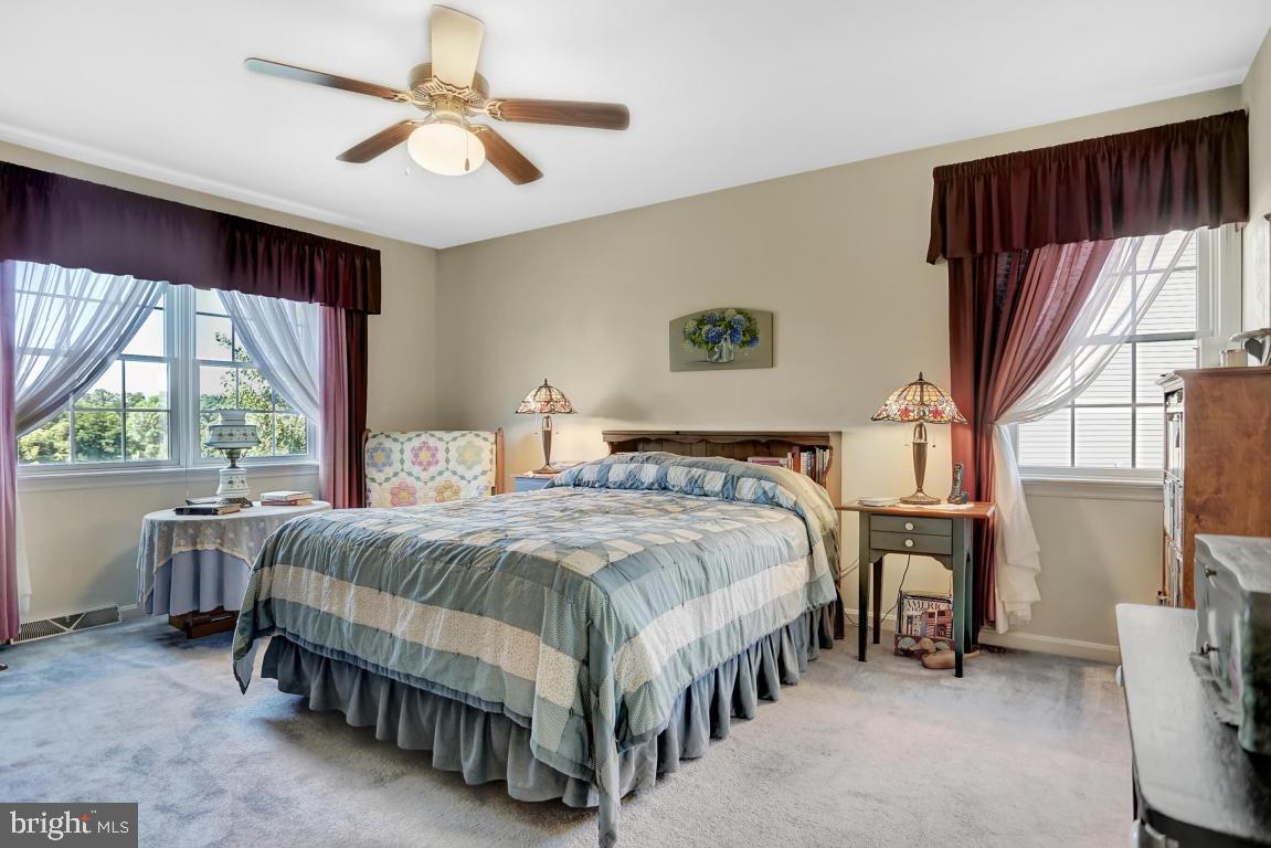 12 Sunset Lane Lititz, PA 17543 - Photo 16 of 34 a bedroom with a large bed and a chandelier