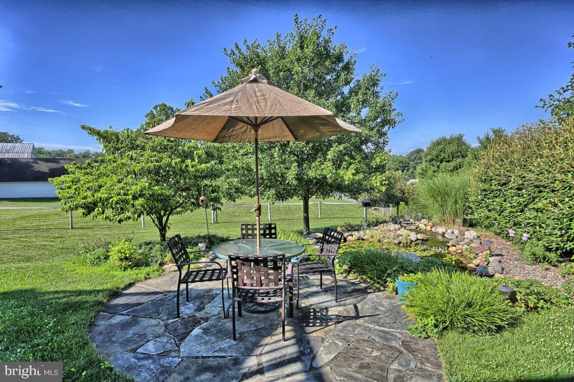 12 Sunset Lane Lititz, PA 17543 - Photo 27 of 34 a view of a backyard with furniture and a garden