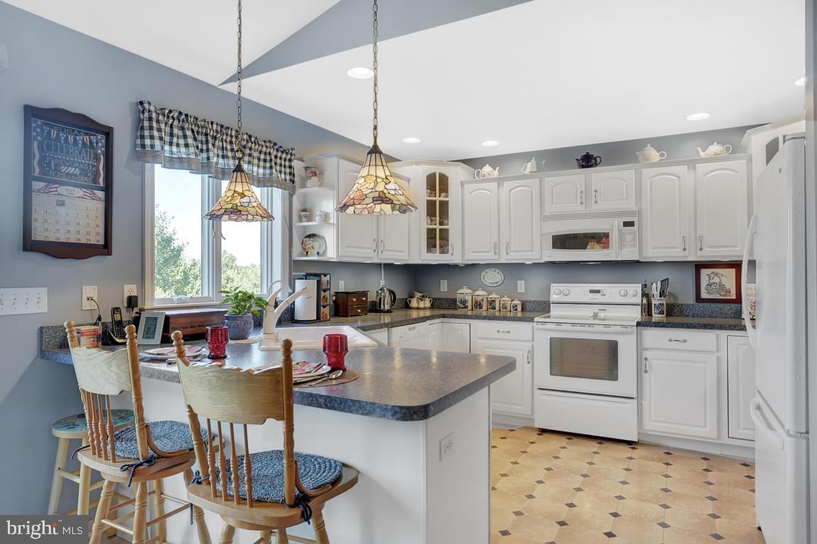 12 Sunset Lane Lititz, PA 17543 - Photo 6 of 34 a kitchen with kitchen island granite countertop a sink cabinets and window