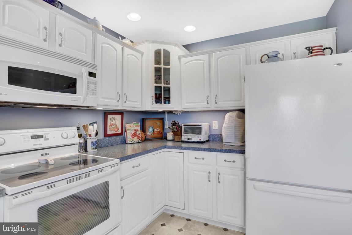 12 Sunset Lane Lititz, PA 17543 - Photo 7 of 34 a kitchen with stainless steel appliances granite countertop white cabinets and a refrigerator