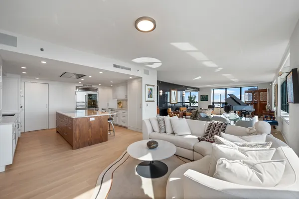 a living room with furniture and kitchen view