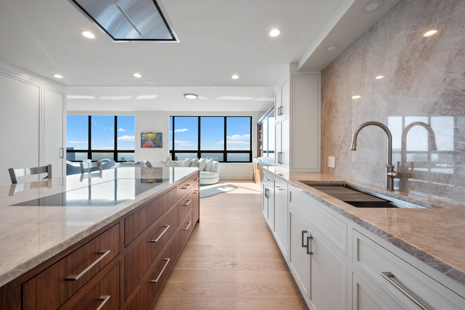 180 East Pearson Street, Unit 6907 Chicago, IL 60611 - Photo 13 of 44 a large kitchen with granite countertop a large counter top a sink stainless steel appliances and cabinets