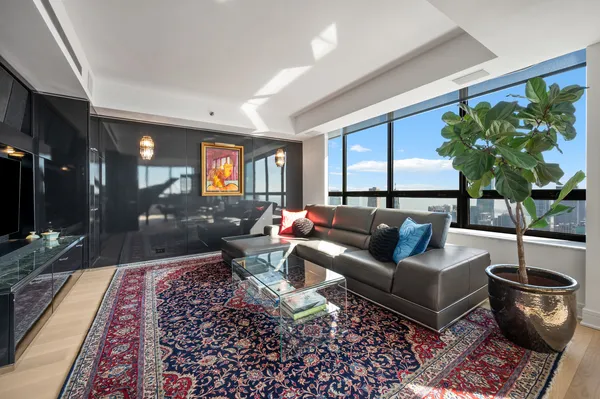 a living room with furniture and a potted plant