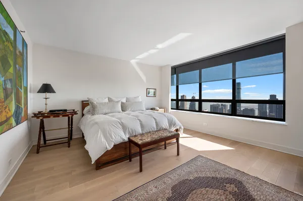 a spacious bedroom with a large bed and a large window