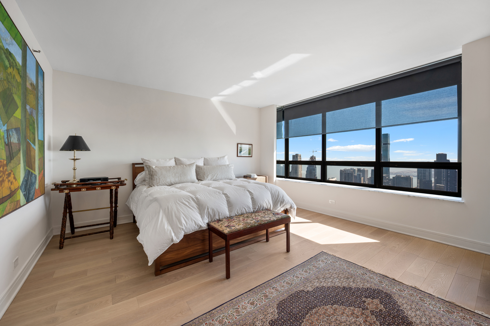 180 East Pearson Street, Unit 6907 Chicago, IL 60611 - Photo 20 of 44 a spacious bedroom with a large bed and a large window