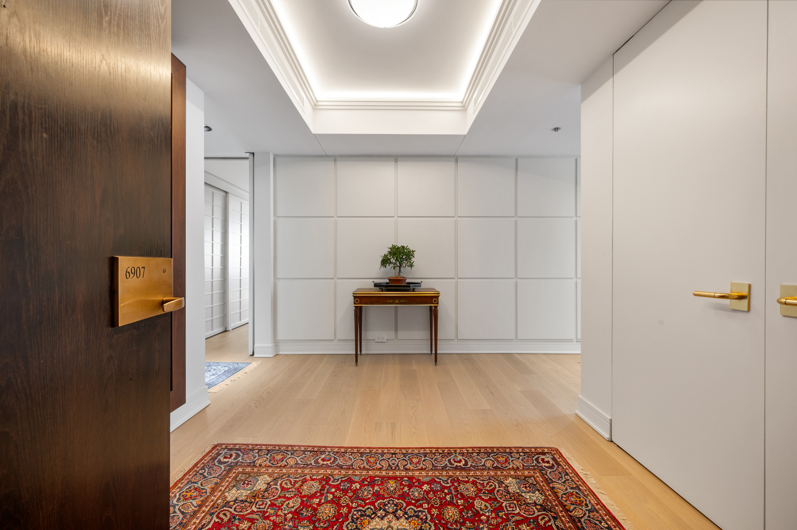 180 East Pearson Street, Unit 6907 Chicago, IL 60611 - Photo 2 of 44 a bedroom with a bed and a lamp on table