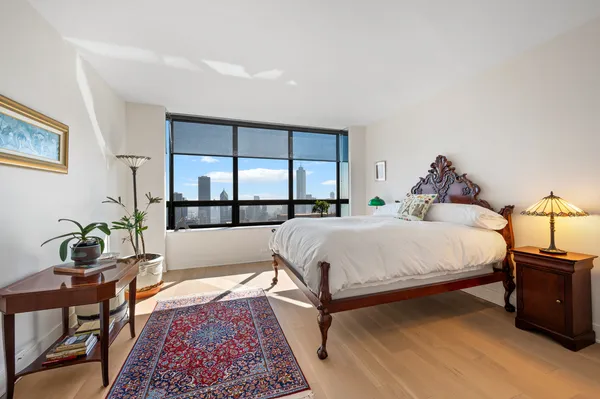 a bed room with a bed and a potted plant