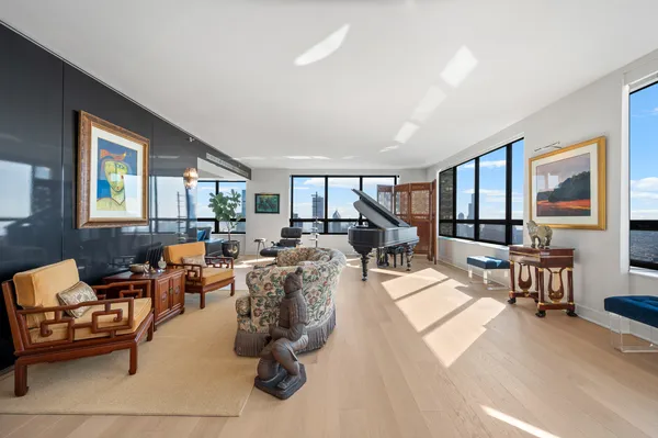 a living room with furniture large window and a table