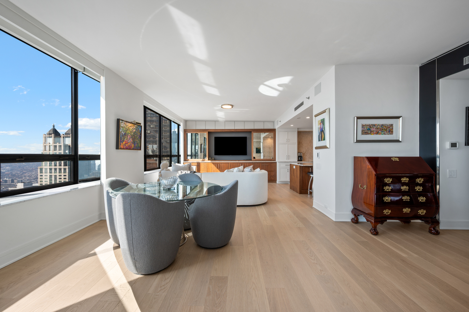 180 East Pearson Street, Unit 6907 Chicago, IL 60611 - Photo 7 of 44 a living room with furniture a flat screen tv and a floor to ceiling window