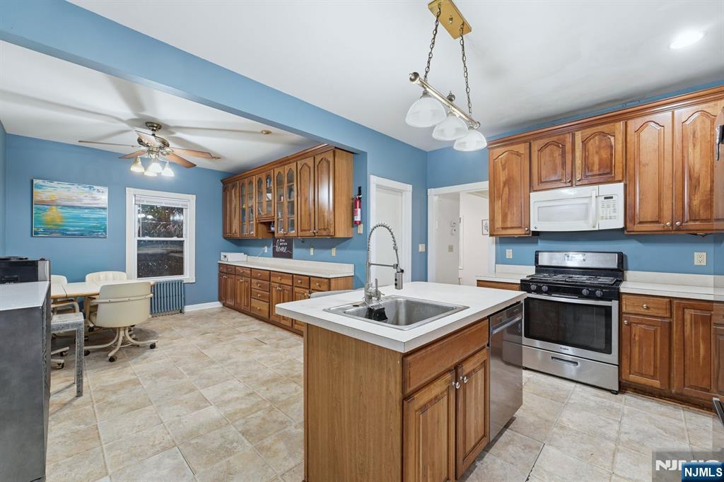 31 West Street Closter, NJ 07624 - Photo 5 of 18 a kitchen with stainless steel appliances granite countertop a sink stove and refrigerator