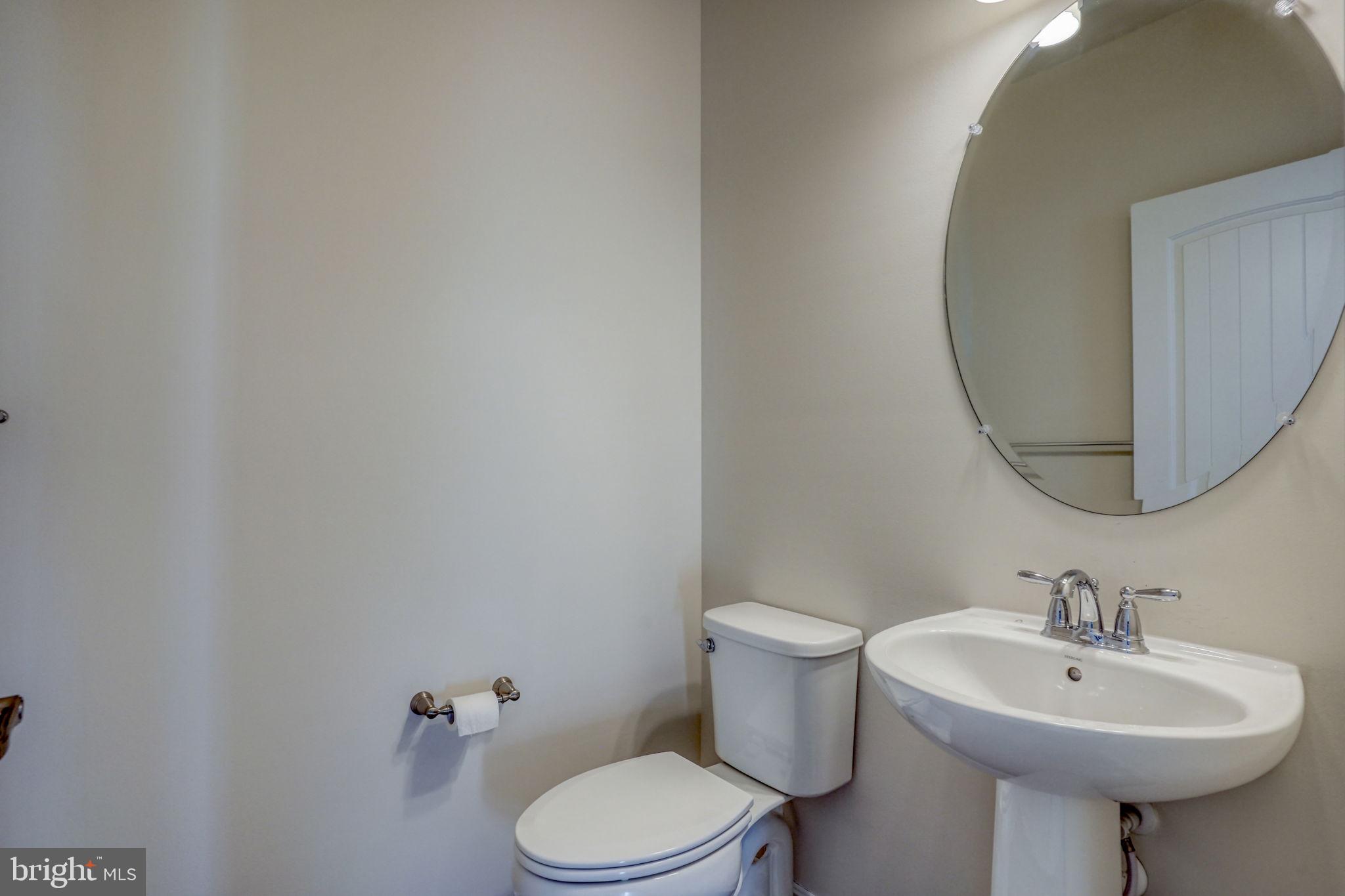 33908 Ardwell Road Frankford, DE 19945 - Photo 12 of 44 a bathroom with a sink a toilet and mirror