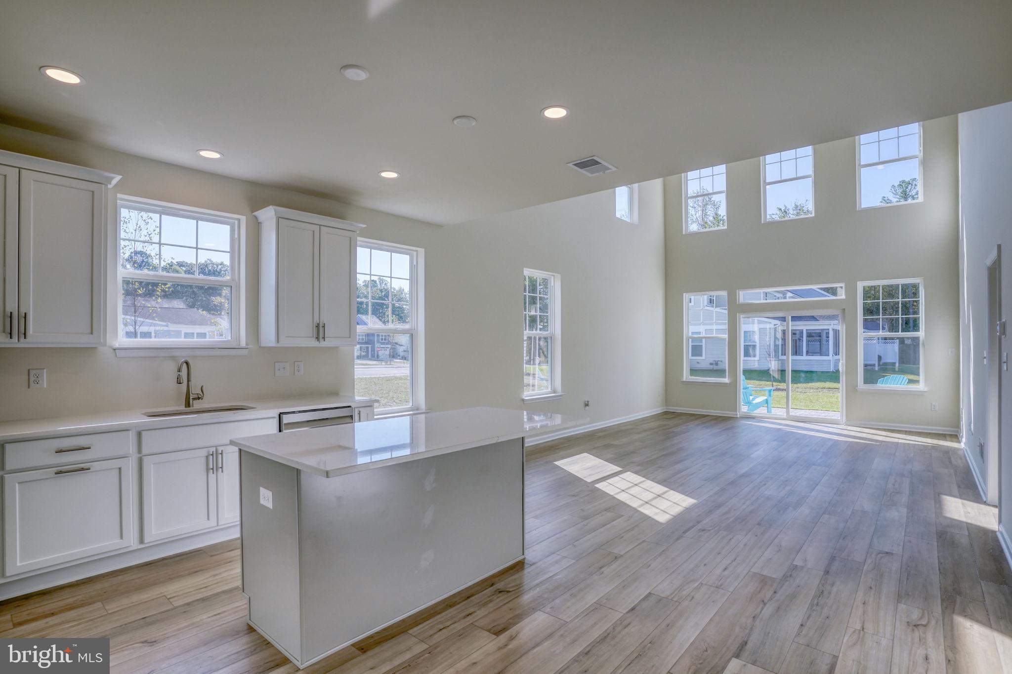 33908 Ardwell Road Frankford, DE 19945 - Photo 13 of 44 a view of kitchen and hall with wooden floor