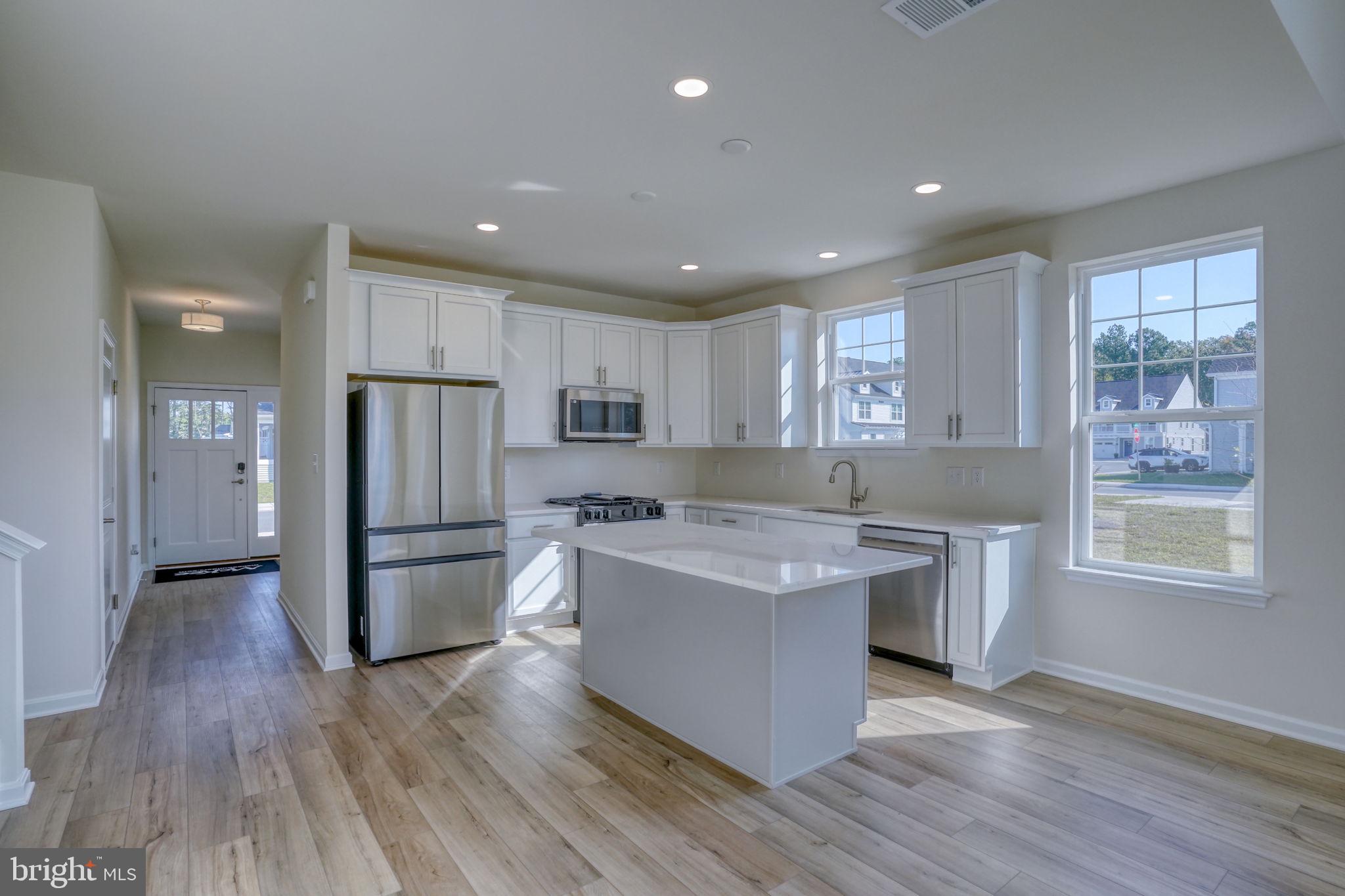 33908 Ardwell Road Frankford, DE 19945 - Photo 14 of 44 a kitchen with stainless steel appliances granite countertop a refrigerator a stove a sink and a microwave