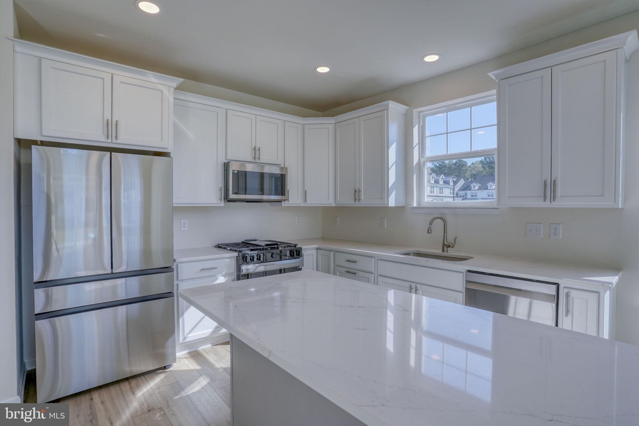 33908 Ardwell Road Frankford, DE 19945 - Photo 15 of 44 a kitchen with stainless steel appliances granite countertop a refrigerator sink and microwave
