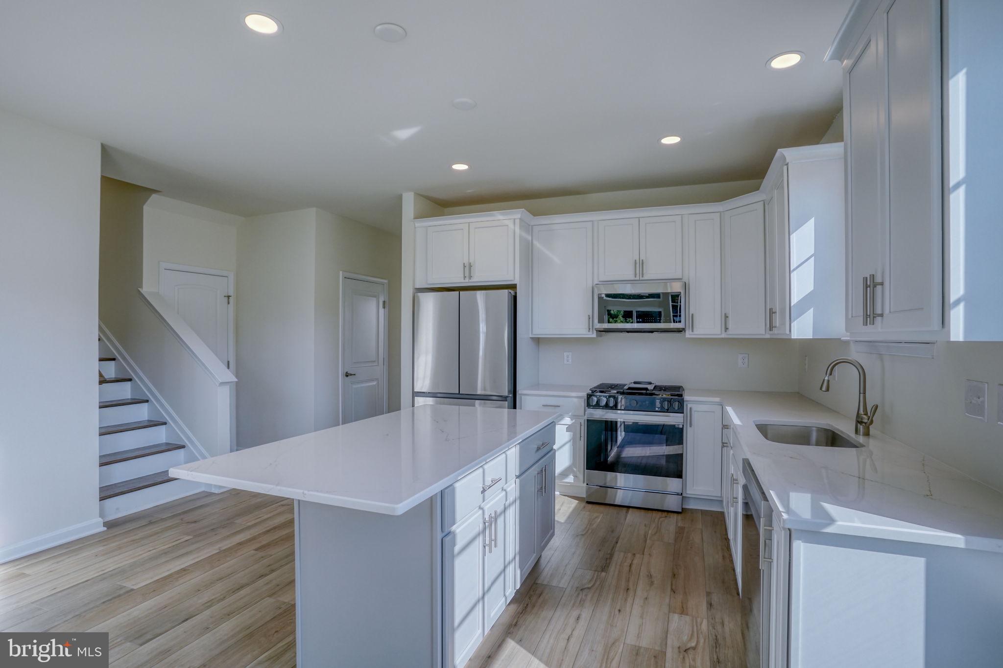 33908 Ardwell Road Frankford, DE 19945 - Photo 16 of 44 a kitchen with granite countertop a sink stove and refrigerator
