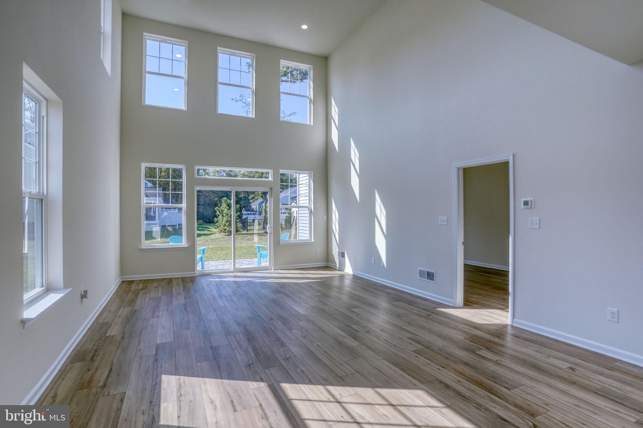 33908 Ardwell Road Frankford, DE 19945 - Photo 18 of 44 a view of an empty room with glass door and wooden floor