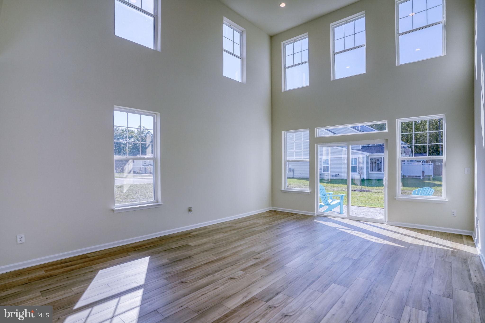 33908 Ardwell Road Frankford, DE 19945 - Photo 19 of 44 a view of an empty room with wooden floor and a window
