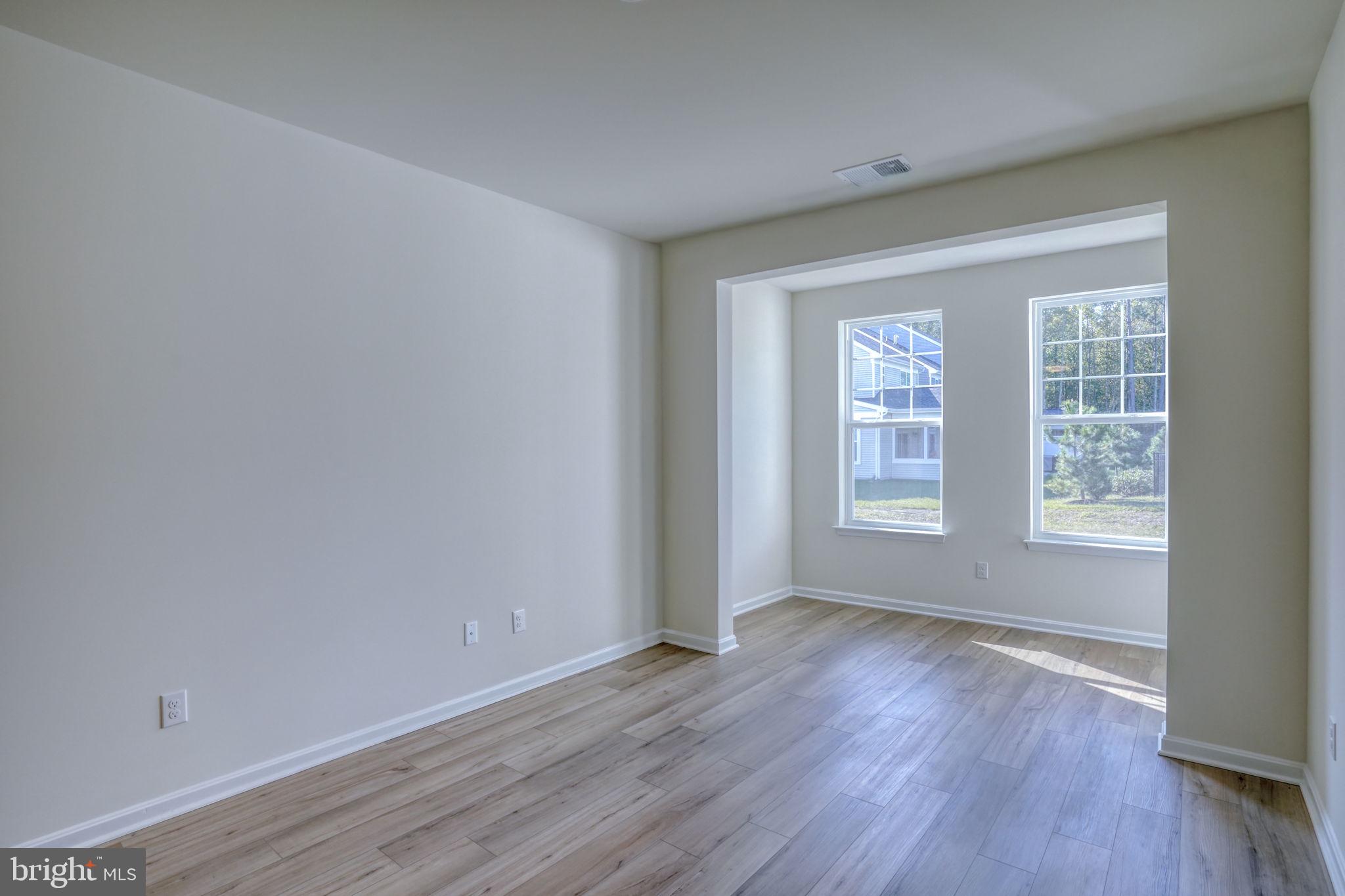 33908 Ardwell Road Frankford, DE 19945 - Photo 22 of 44 an empty room with wooden floor and windows