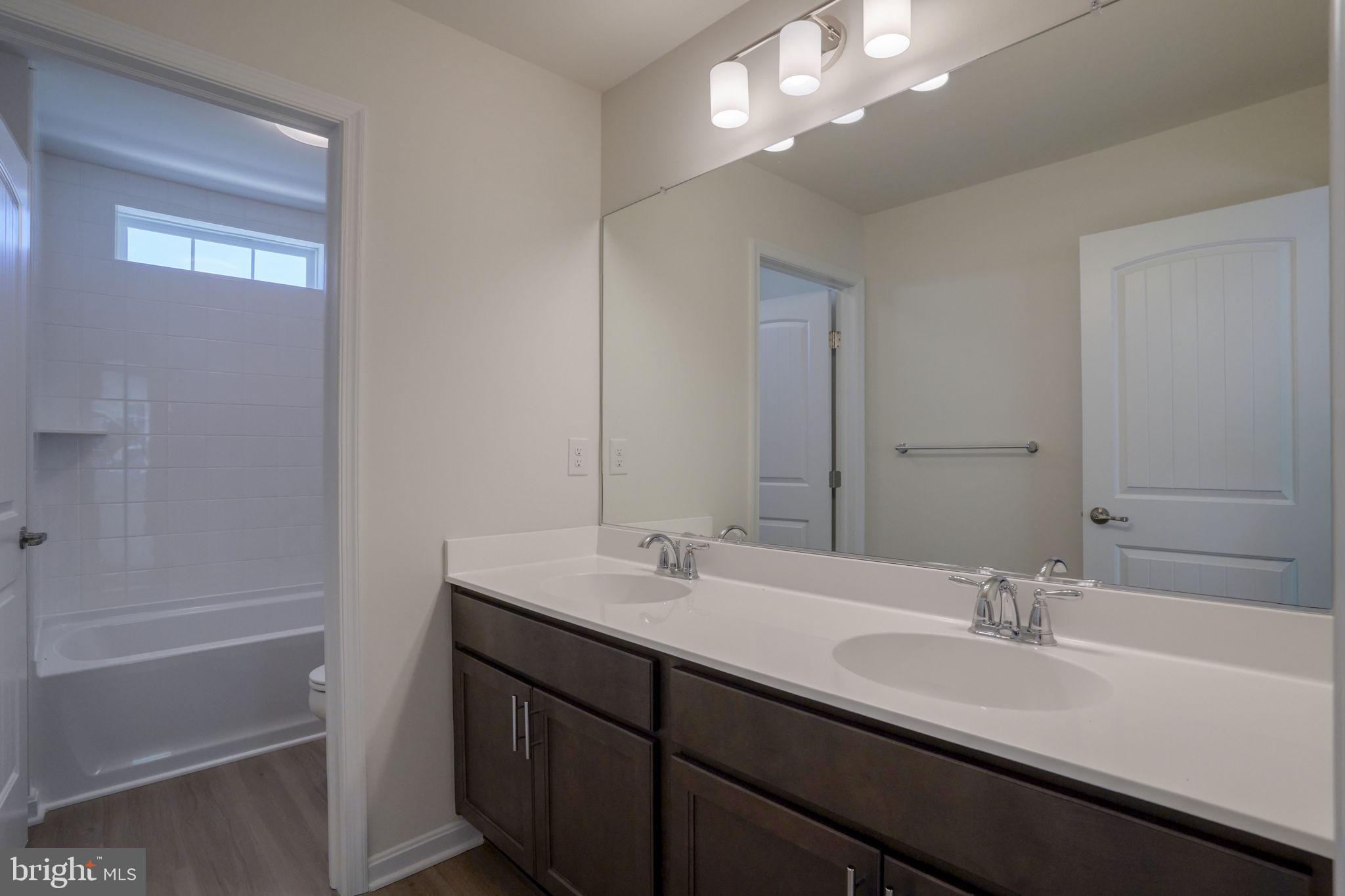 33908 Ardwell Road Frankford, DE 19945 - Photo 27 of 44 a bathroom with a sink a vanity and a mirror