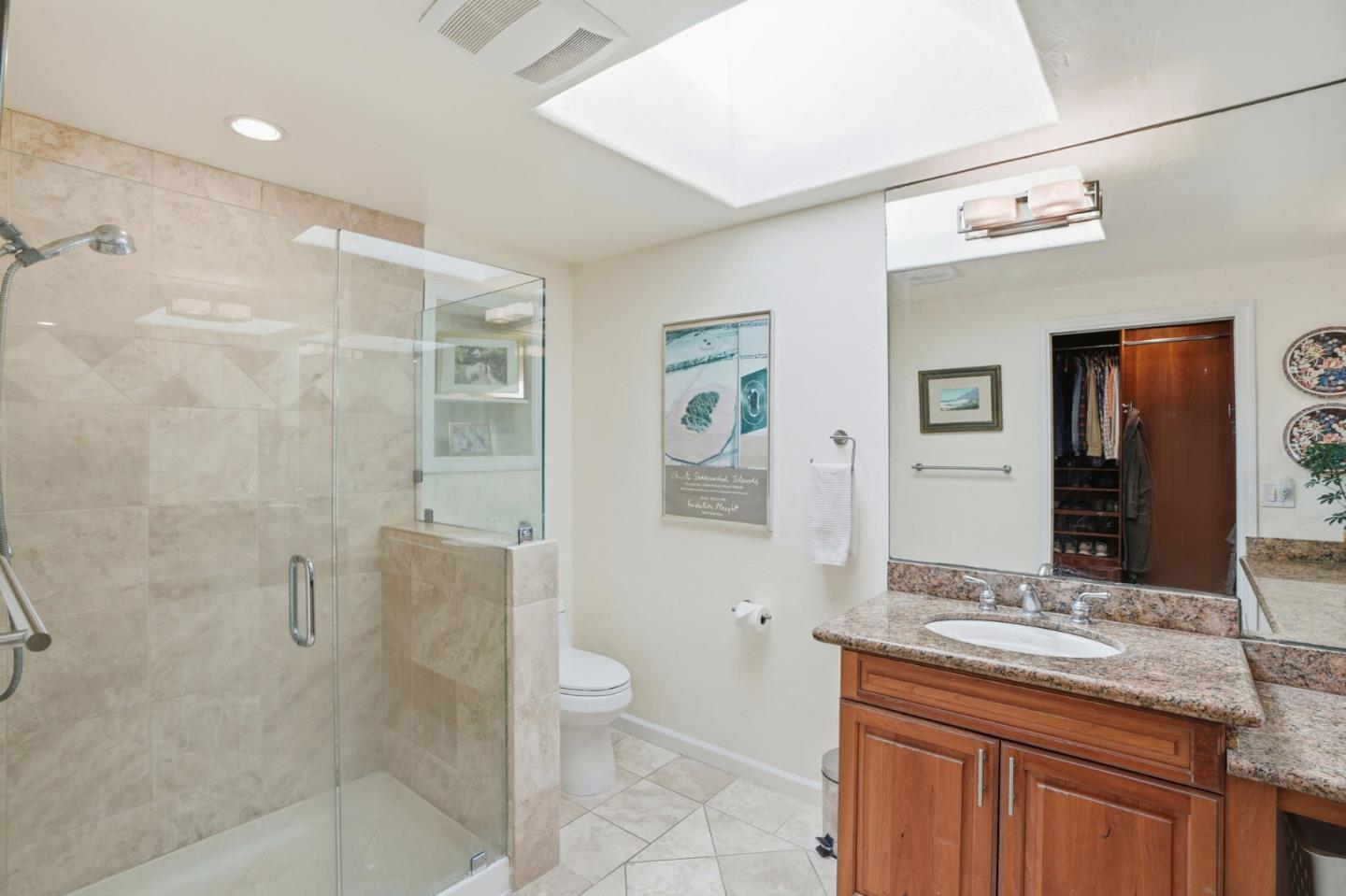 329 Stuart Avenue Pacific Grove, CA 93950 - Photo 16 of 33 a bathroom with a granite countertop sink a toilet and shower