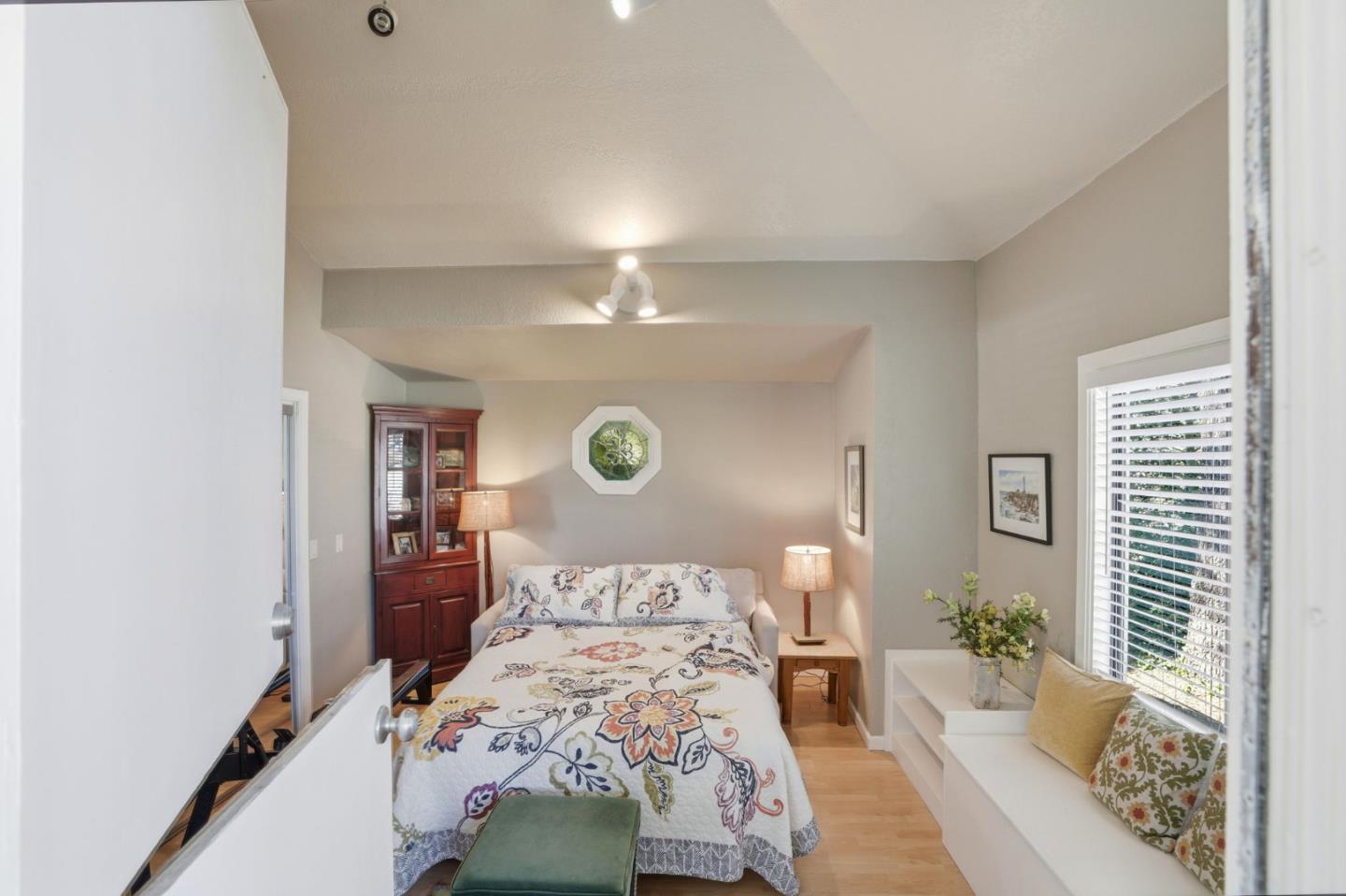 329 Stuart Avenue Pacific Grove, CA 93950 - Photo 24 of 33 a bedroom with a bed and a chandelier