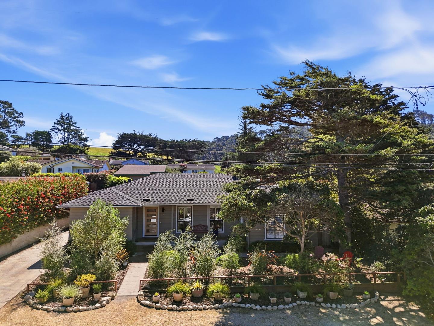 329 Stuart Avenue Pacific Grove, CA 93950 - Photo 4 of 33 a view of a house with a yard and garden
