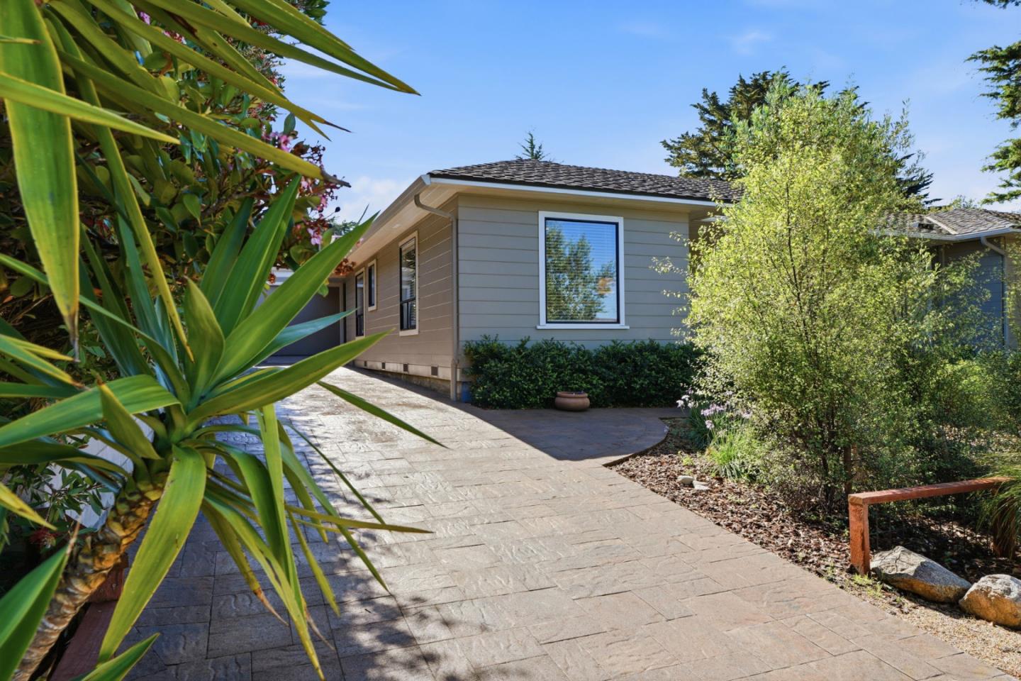 329 Stuart Avenue Pacific Grove, CA 93950 - Photo 7 of 33 a house with trees in front of it