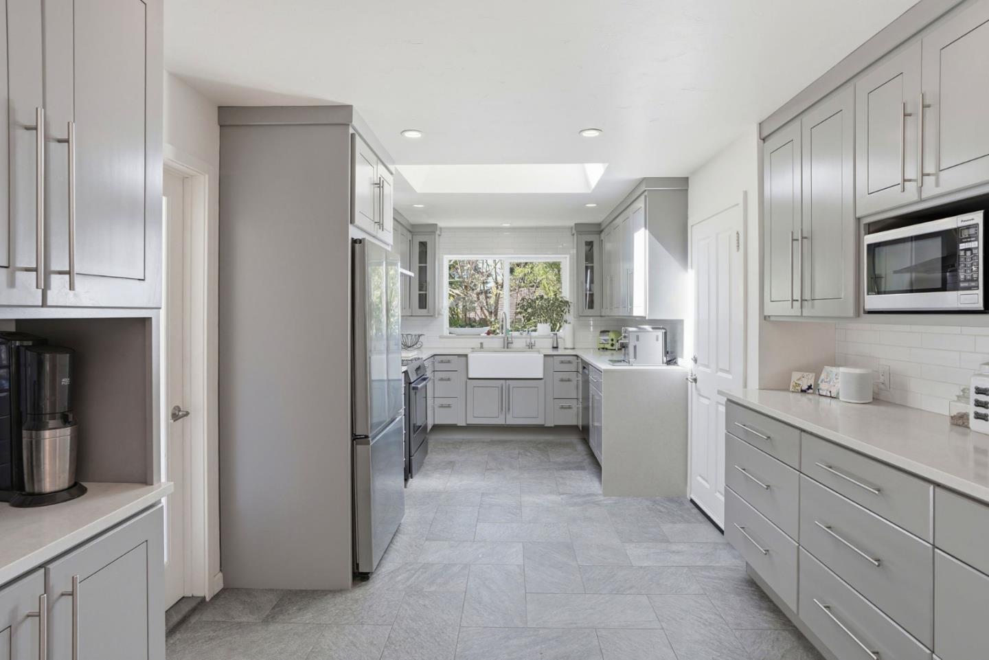 329 Stuart Avenue Pacific Grove, CA 93950 - Photo 9 of 33 a large white kitchen with a sink stainless steel appliances and cabinets