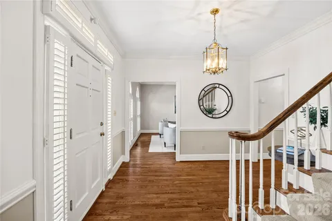 a view of a hallway with wooden floor and a front door