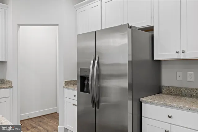 a kitchen with a refrigerator and cabinets