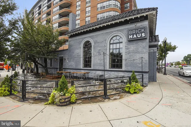 a front view of a building with outdoor seating