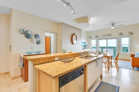 a kitchen with a stove a sink and a refrigerator