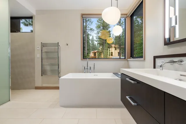 a bathroom with a sink a bathtub and window