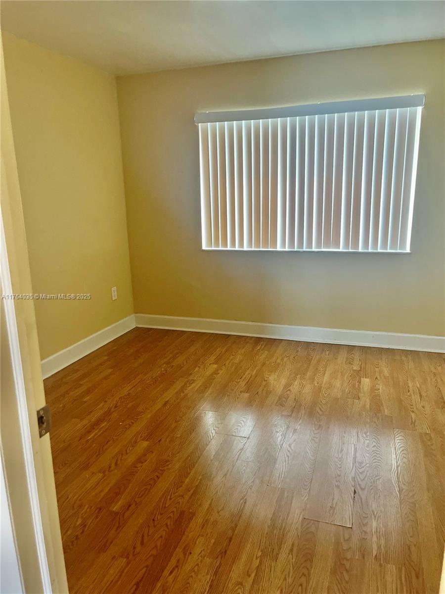 8430 Northwest 8th Street, Unit A11 Miami, FL 33126 - Photo 17 of 23 a view of wooden floor in a room