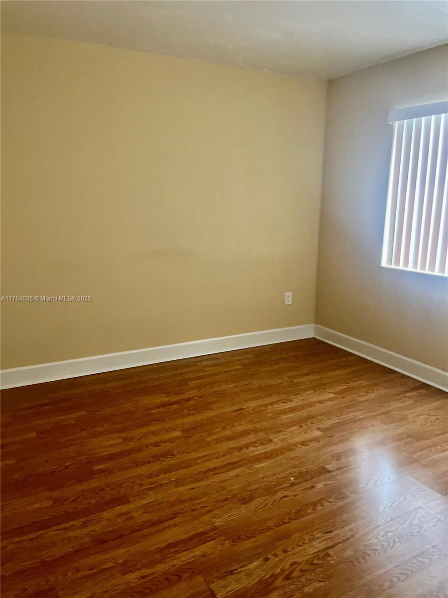 8430 Northwest 8th Street, Unit A11 Miami, FL 33126 - Photo 18 of 23 a view of a room with wooden floor and window