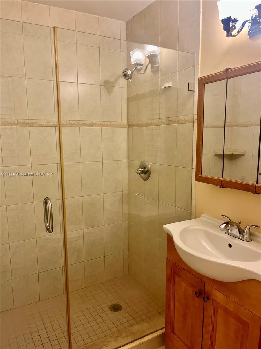 8430 Northwest 8th Street, Unit A11 Miami, FL 33126 - Photo 21 of 23 a bathroom with a shower and a sink