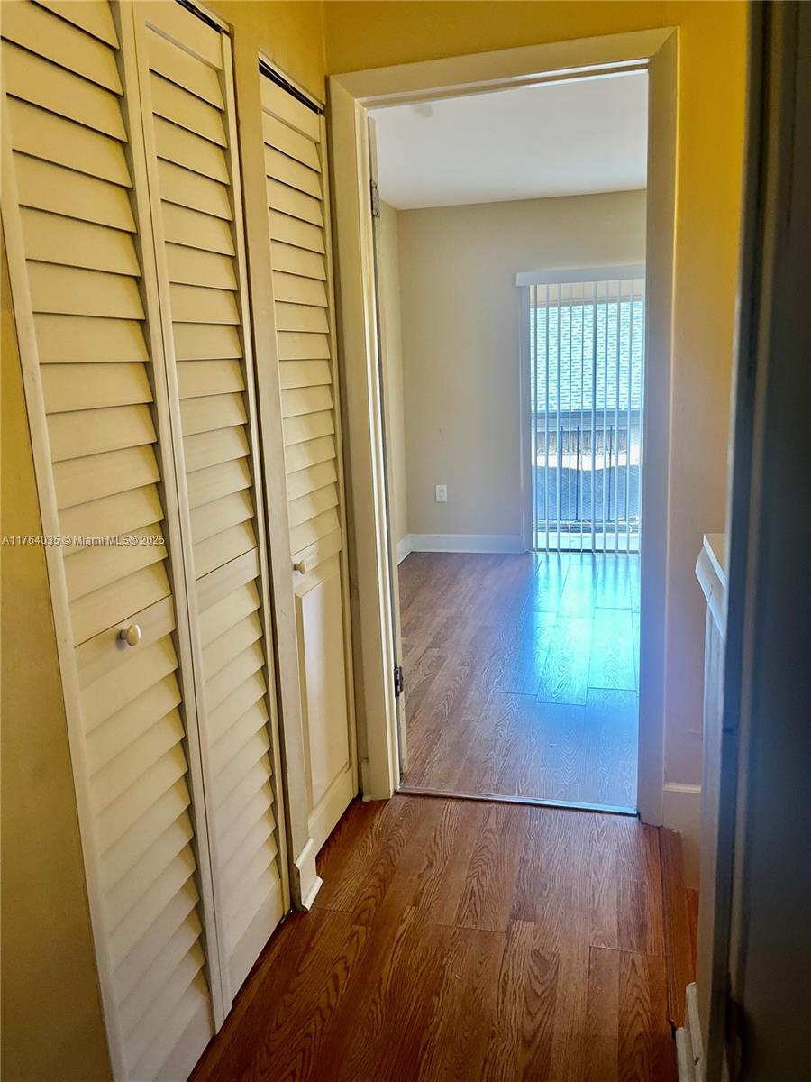 8430 Northwest 8th Street, Unit A11 Miami, FL 33126 - Photo 23 of 23 an entryway with wooden floor and a door