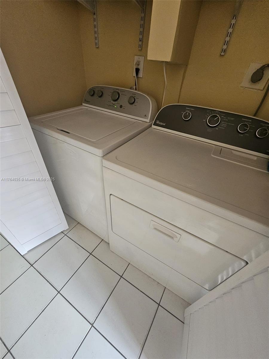 8430 Northwest 8th Street, Unit A11 Miami, FL 33126 - Photo 10 of 23 a utility room with dryer and washer