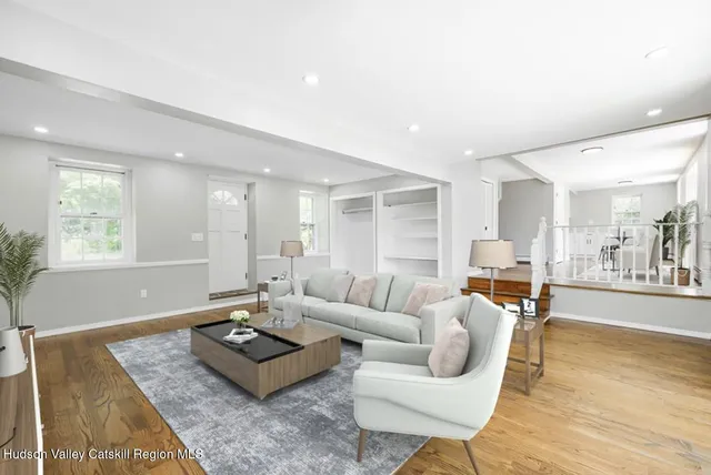 a living room with furniture and wooden floor