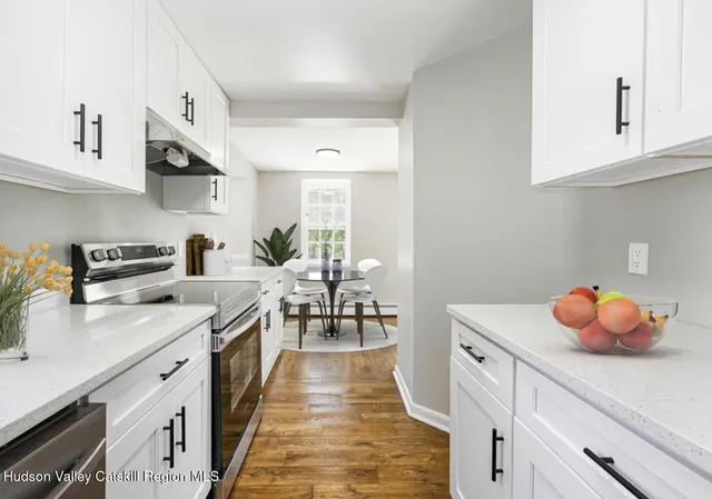 a kitchen with stainless steel appliances a sink counter space and cabinets