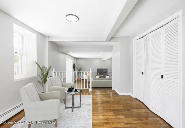 a living room with furniture and wooden floor
