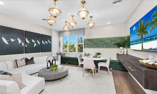 a room with a table chairs and a workspace